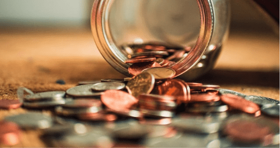 Jar with coins spilling out