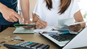 Couple looking over debt and paperwork