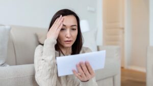 Worried woman holding a letter