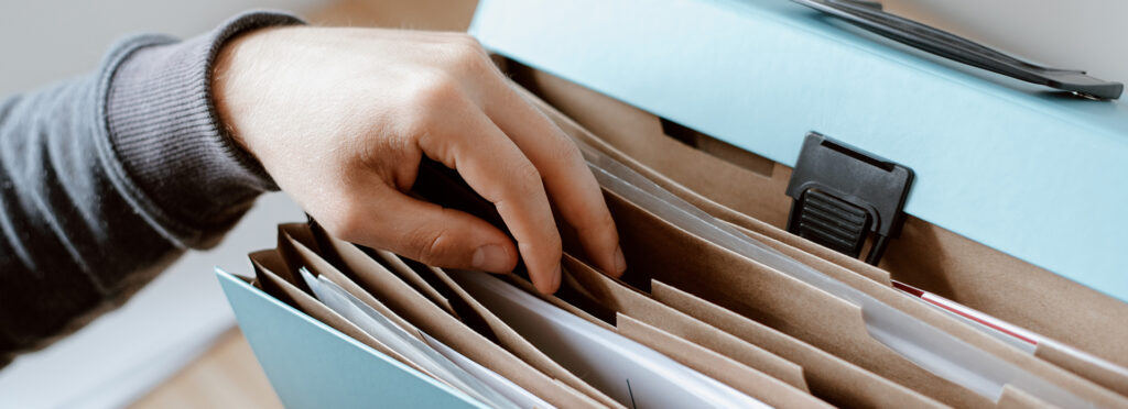 person looking through file folder